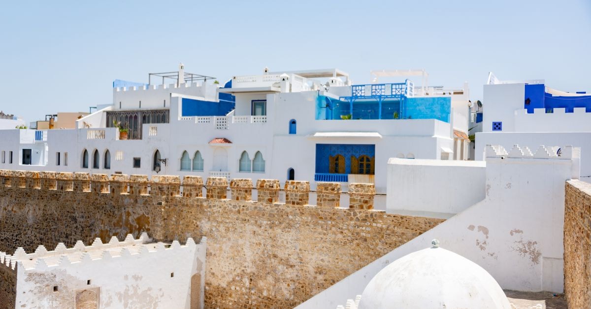 Explore stunning white and blue architecture in a peaceful Mediterranean setting under a clear blue sky.