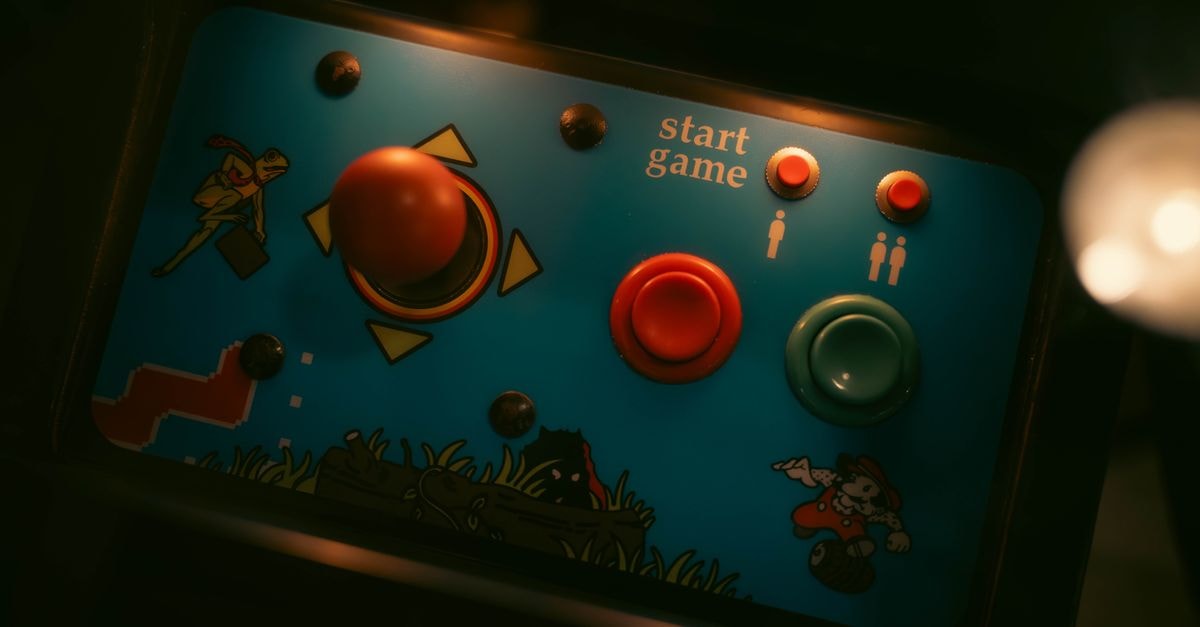 Close-up of retro arcade game controls with joystick and buttons