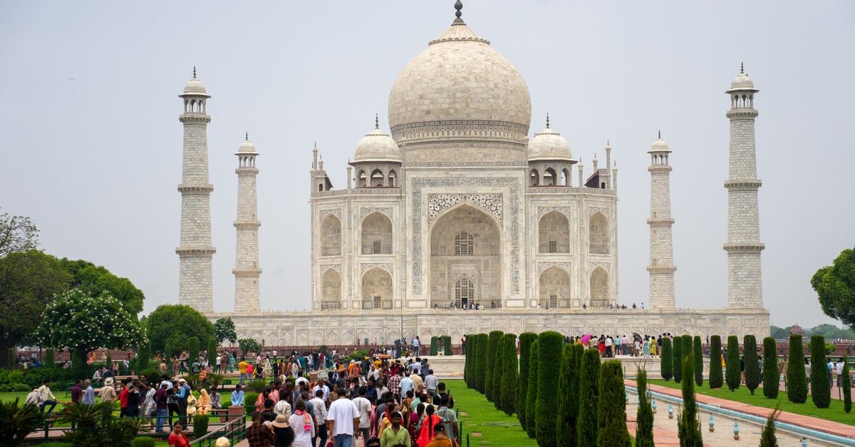 Hotel Sidhartha, Agra: Steps from the Taj Mahal Eastern Gate Iconic Taj Mahal in Agra, India bustling with tourists on a bright day.
