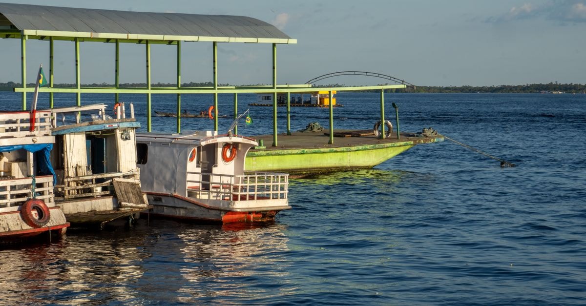 Parauapebas Travel Guide: Frontier City Meets Amazon Riverboats and dock on Rio Negro in Manaus, capturing serene water views.