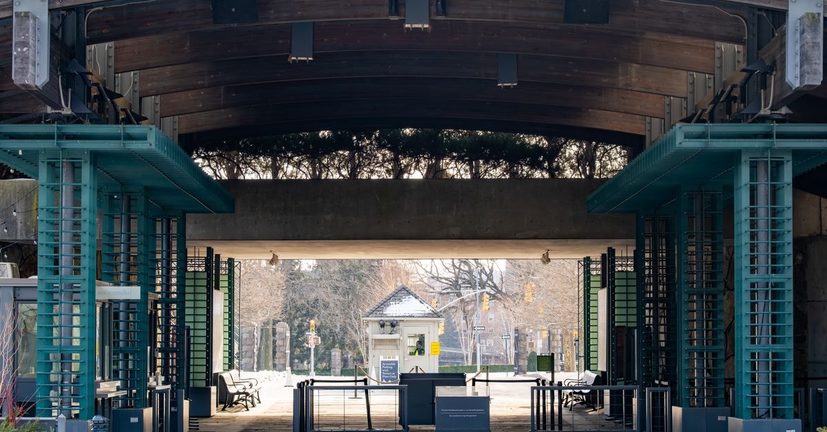 Explore a modern urban passageway with industrial design and symmetrical structure, featuring benches and steel elements.