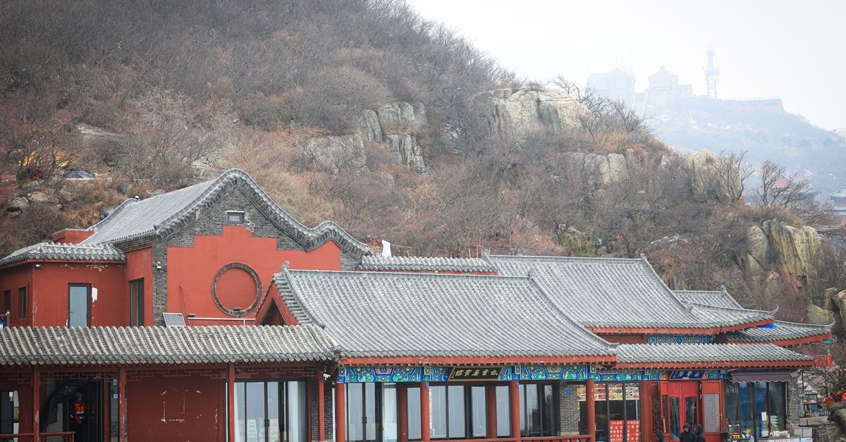 Xingtai Travel Guide: An Ancient City Framed by Mountains A scenic view of a traditional Chinese building set against a mountain backdrop.