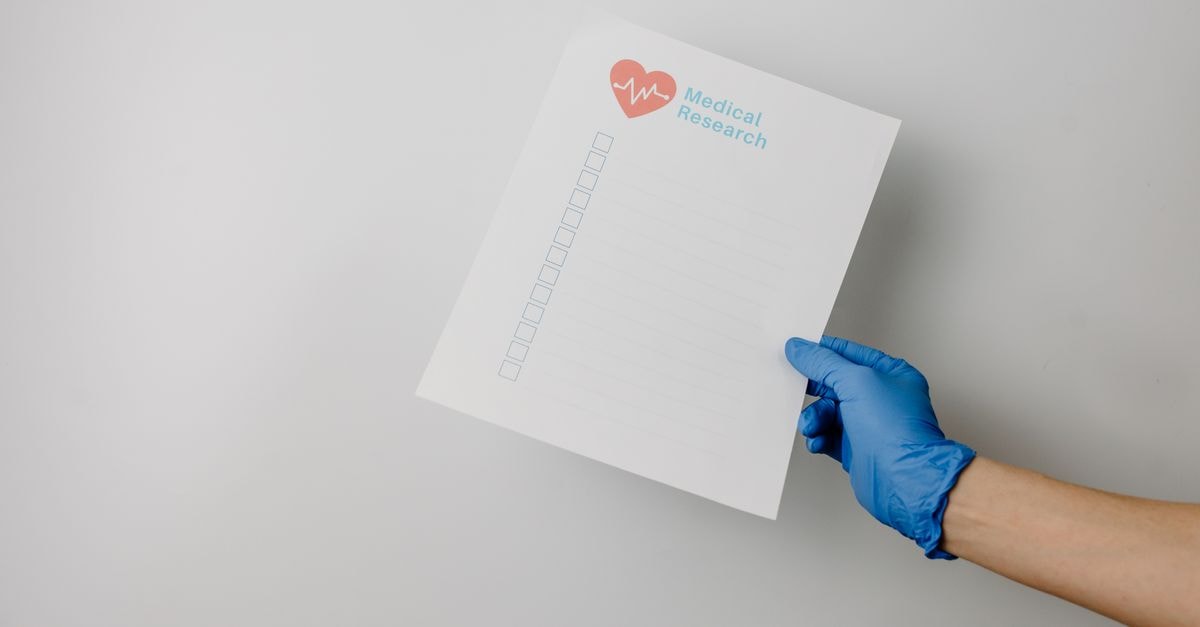 A gloved hand holding a paper titled 'Medical Research' with checkboxes.