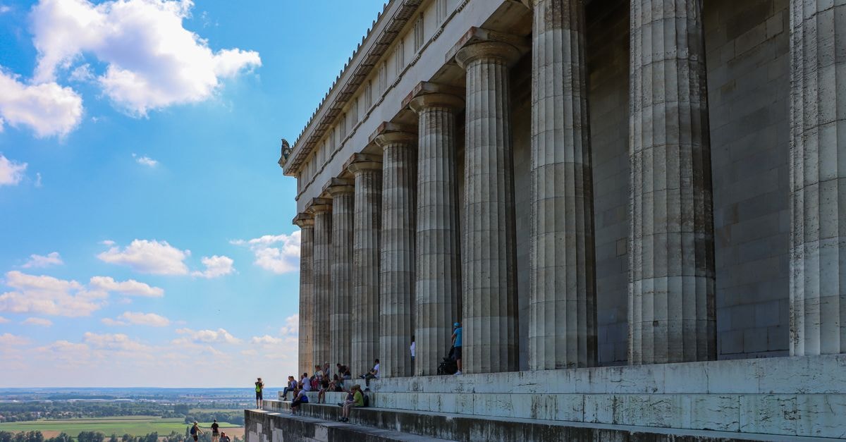 A striking view of the Walhalla memorial's grand columns under the summer sky near Regensburg, Germany.