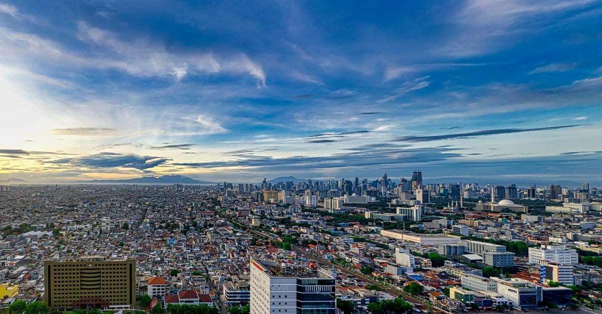 Leedon Hotel & Suites Surabaya: Ginger-Scented Lobby on Jalan Kecilung Stunning aerial view of Jakarta's cityscape at dusk, capturing its modern skyline and urban sprawl.
